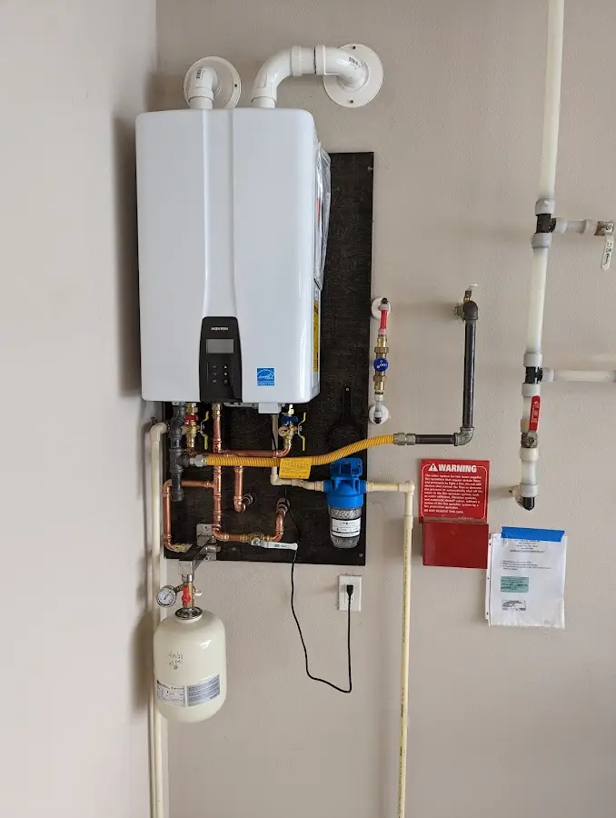 Professional plumber installing copper piping in a Mayfair home